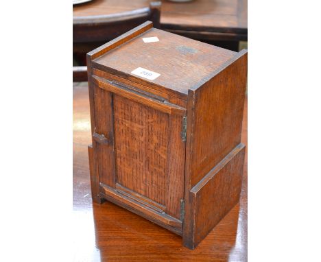 An oak smoker's cabinet with oak tobacco jar