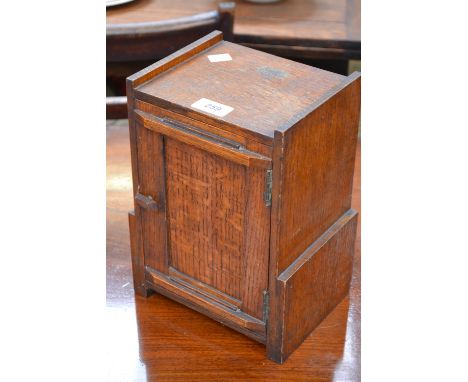 An oak smoker's cabinet with oak tobacco jar