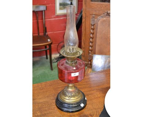 A Victorian cranberry glass table oil lamp, c.1880