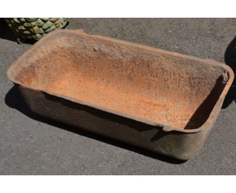 A cast iron feeding trough