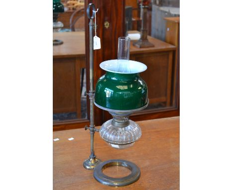 A Victorian oil lantern with adjustable brass holder, green glass shade, clear glass reservoir. 