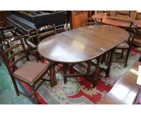 An oak drop leaf gateleg table and four oak ladder back chairs 