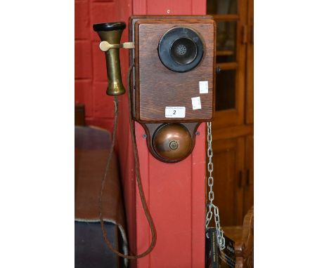 An early 20th century wall mounded candlestick phone
