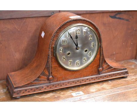 An oak 1930's mantel clock, silvered dial, brass Arabic numerals