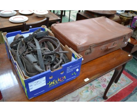 A vintage leather suitcase; leather horse harness (2)