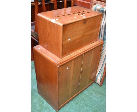 A 1940's walnut veneered writing cabinet, fall front enclosing pigeon holes and drawer, two door cupboard to base, enclosing 