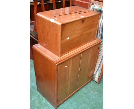 A 1940's walnut veneered writing cabinet, fall front enclosing pigeon holes and drawer, two door cupboard to base, enclosing 