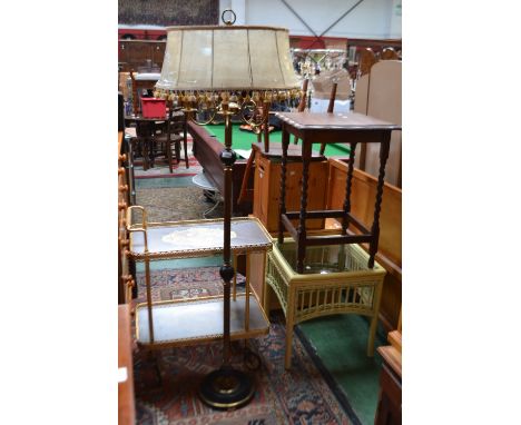 An oak barley twist occasional table; a glass topped bamboo occasional table; a gilt metal tea trolley; a gilt metal standard