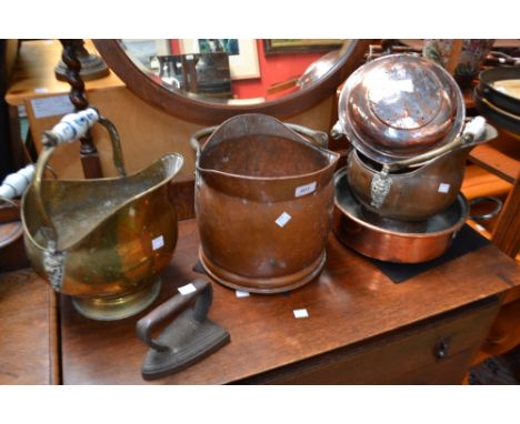 Metalware- a Victorian brass helmet coal scuttle, Delft pottery handle; others; a twin handle copper pan, eight roundel base;
