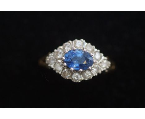 18ct Gold ring set with 12 diamonds &amp; central sapphire. Size K 