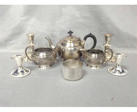 THREE PIECE SILVER PLATED TEA SERVICE,TWO PAIRS OF PLATED CANDLESTICKS AND A PLATED SUGAR BOWL WITH SPOON.