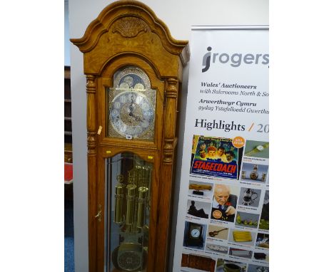 Modern Howard Miller moon dial grandfather clock, triple weight, chiming timepiece with oversized pendulum regulator, in a li