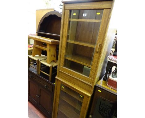 Pair of near matching light oak cabinets with single glass doors