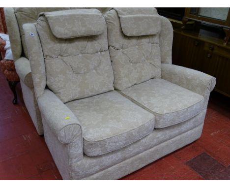 Light floral upholstered two seater couch