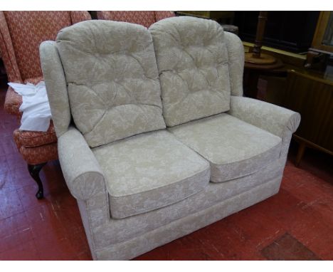 Light floral upholstered two seater couch