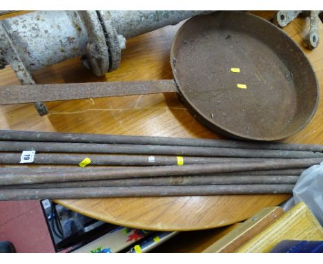 Parcel of vintage brass stair rods and a large cast frying pan