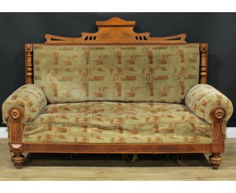 A late Victorian Eastlake style sofa, rectangular back crested by a shaped pediment incised with a lyre and flanked by turned