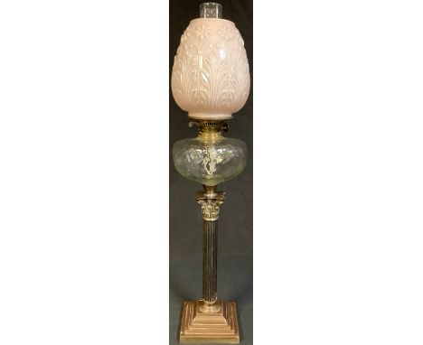A late Victorian brass oil lamp, twin burner, opaque moulded pink glass shade, chimney 