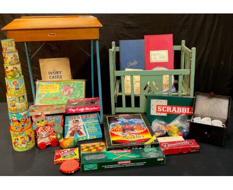 Toys and Games - a Tri-ang child's desk; a doll's crib, transfer printed; a Chad Valley Wee-kin circular pile ups, 1950s, box