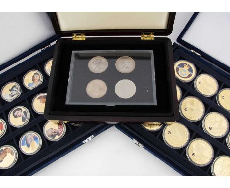 PLEASE NOTE REVISION OF ESTIMATE!A Large collection of commemorative coins, stamps and medallions, housed in various wooden p