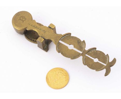 A George V half gold sovereign and a set of brass sovereign scales, dated 1914, VF, the scales made by Harrison (2)
