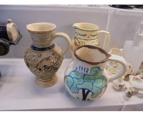 A Honiton pottery jug and two others.