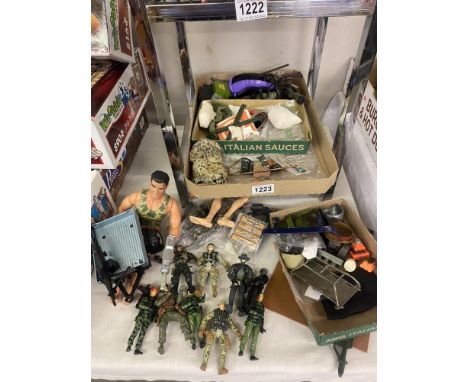 A box of Action man dolls and clothes.
