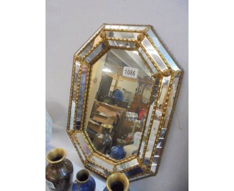 A brass multi-framed bevel edged gypsy mirror.