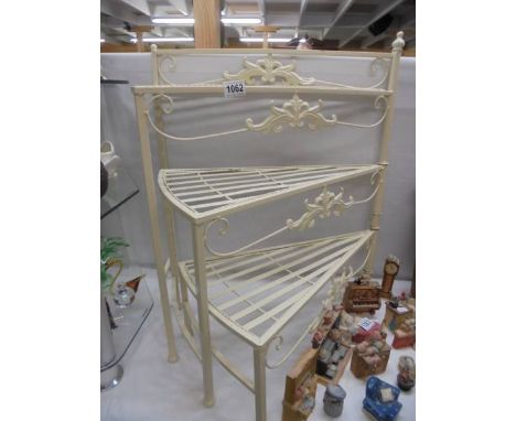 A wrought iron adjustable library steps style plant stand.