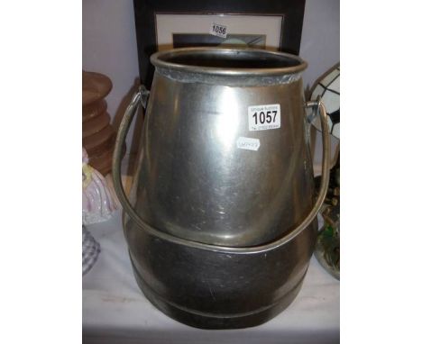 A stainless steel milk churn.