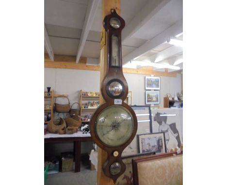 A Victorian wheel barometer with silvered dial.