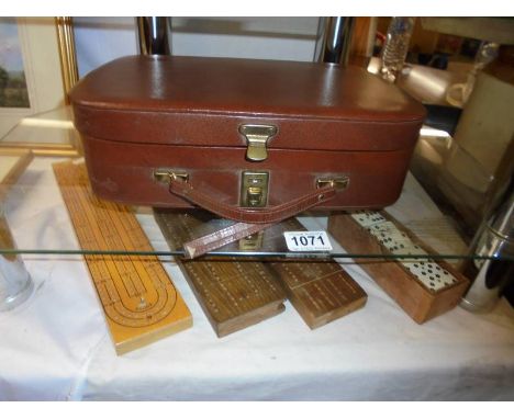 3 vintage cribbage boards, a set of dominoes and a writing case.