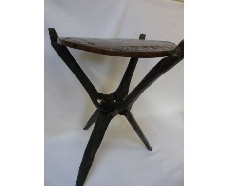 Carved wooden games table on folding tripod stand and games pieces