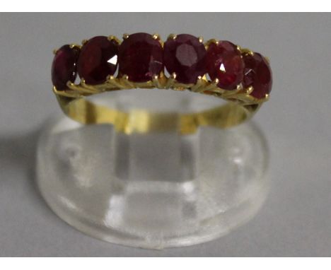 A SIX STONE RUBY RING, set in 22ct yellow gold.