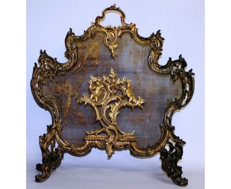 A GOOD LOUIS XVI ORMOLU FIRESCREEN with rush work back, scrolls and cupids. 30ins high.