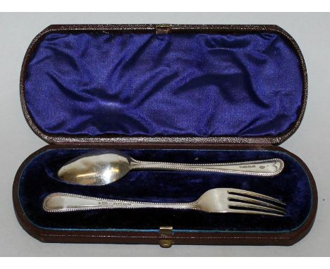 A VICTORIAN CHRISTENING SPOON AND FORK with bead edge, cased. London 1876.