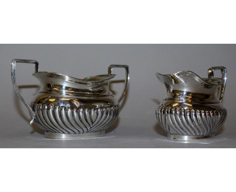 A SEMI FLUTED TWO HANDLED SUGAR BASIN AND MILK JUG. London and Birmingham.  Weight 9ozs.