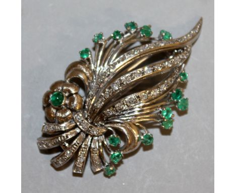 AN 18CT WHITE GOLD DIAMOND AND EMERALD SPRAY BROOCH.