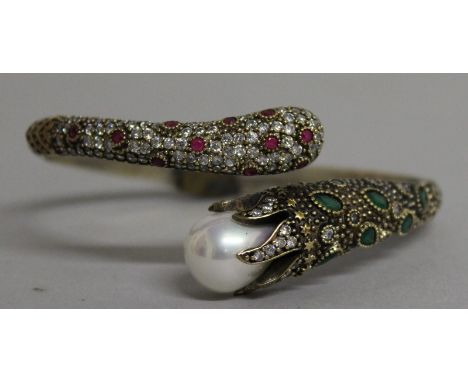 A SILVER SERPENT BANGLE with pearl and brilliants.