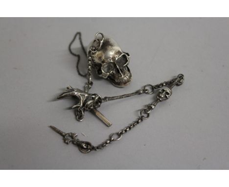 A SILVER SKULL SNUFF BOX on a chain.