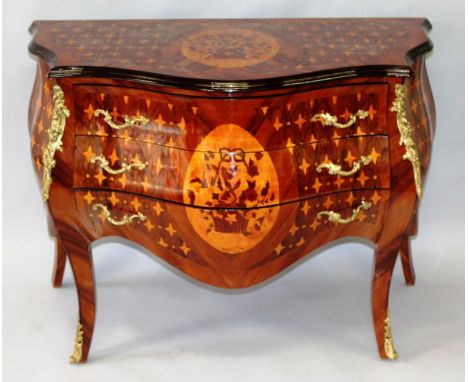 A LOUIS XVI STYLE ROSEWOOD, ORMOLU AND MARQUETRY COMMODE, the top with a basket of flowers and flower head detail, over three