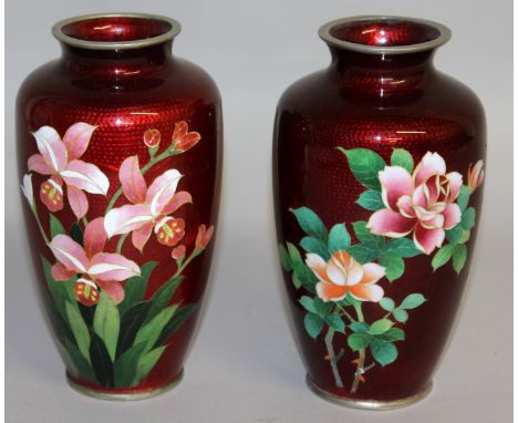 A PAIR OF JAPANESE RED CLOISONNE ENAMEL VASES on silver decorated with roses. 7.5ins high.