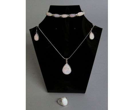 A SUITE OF SILVER AND OPAL JEWELLERY, comprising pendant and chain, pair of drop earrings and oval ring (4).