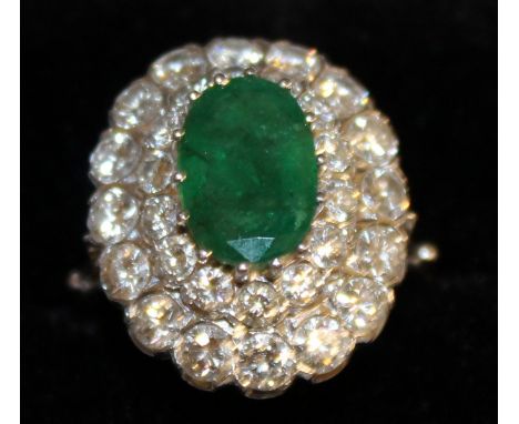 A SUPERB EMERALD AND DIAMOND CLUSTER RING set in 18ct white gold with central emerald and two rows and tiers of diamonds.