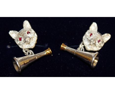 A PAIR OF STERLING SILVER CUFFLINKS, modelled as foxes' head and hunting horn, set with ruby eyes.