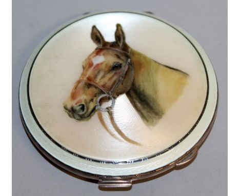 A LADIES SILVER ENGINE TURNED CIRCULAR COMPACT, the lid with an enamel portrait head of a horse.  3ins diameter.