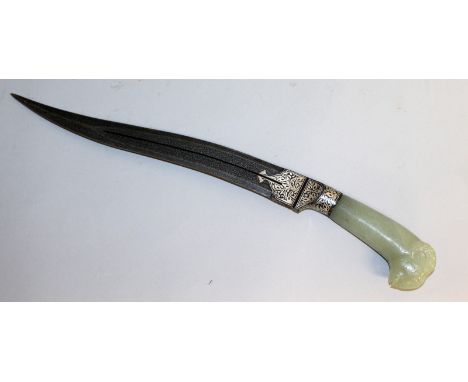 A FINE TURKISH JADE HANDLED KNIFE, "head of a ram", with damask blade. 17ins long.