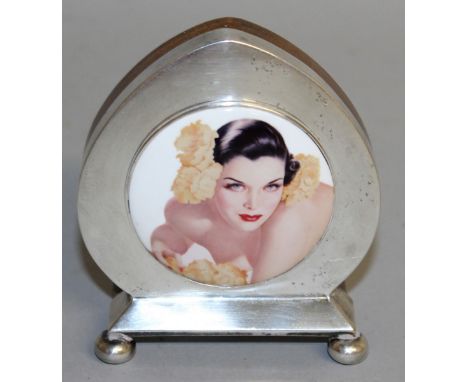 A SHAPED PHOTO FRAME inset with a circular portrait, on three ball feet.  Birmingham 1919.