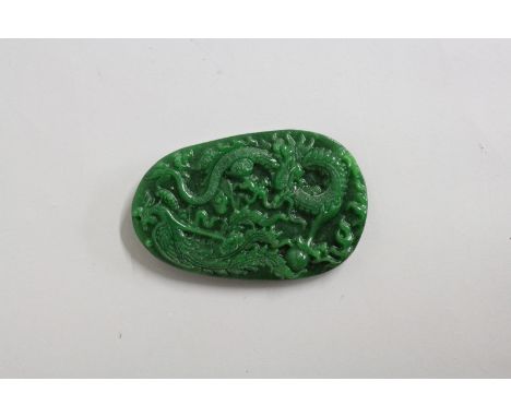 A JADE PENDANT carved with dragons.  3.5ins.