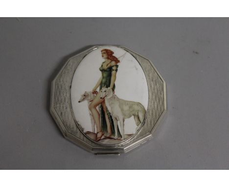 A SILVER ENGINE TURNED OCTAGONAL COMPACT, the front with an oval woman with two borzoi.